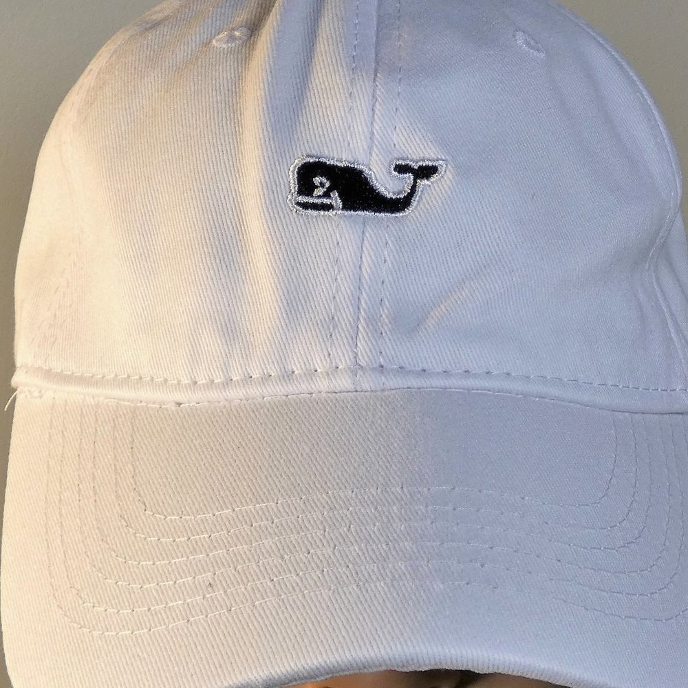 White baseball cap with embroidered navy blue whale on front